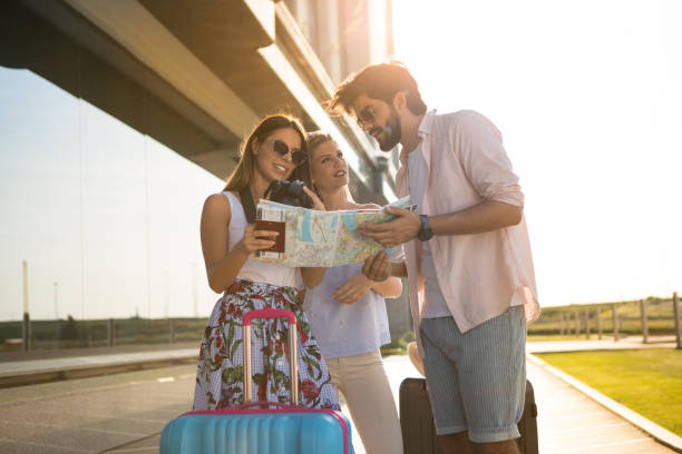istock A very handsome young man shows directions to tourists. 956292592