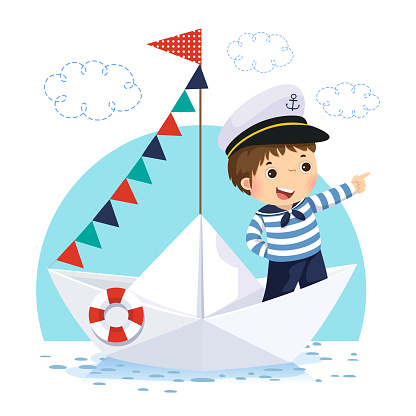 Little boy in sailor costume standing in a paper boat
