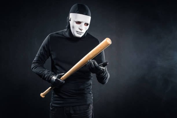 istock Criminal in mask and balaclava holding baseball bat 956296136