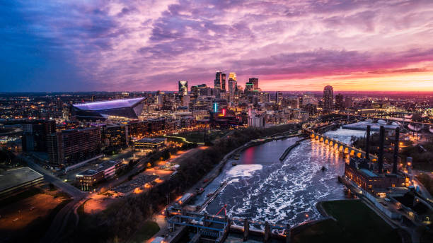 Minneapolis Skyline at Dusk Springtime Sunset over Downtown Minneapolis, St Anthony Falls and Mississippi River - Aerial Shot minnesota stock pictures, royalty-free photos & images