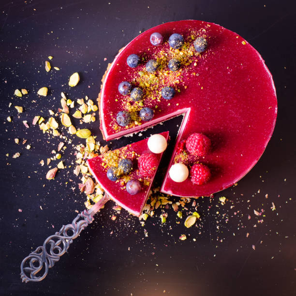 istock Delicious raspberry cake with fresh strawberries, raspberries, blueberry, currants and pistachios on vintage background. Copy space. Banner 956300752