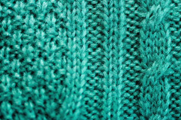 istock Knitted texture. Pattern fabric made of wool. Turquoise background, copy space 956301382