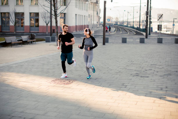 istock Young couple running in the morning 956306596