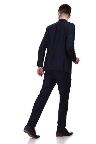 istock back view of walking businessman looking behind 956311640