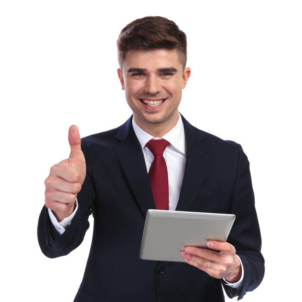 istock smiling businessman holding tablet and making ok sign 956312452