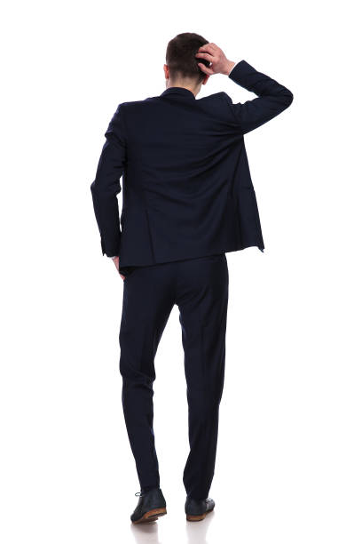 istock back view of businessman scratching his head and thinking 956312964