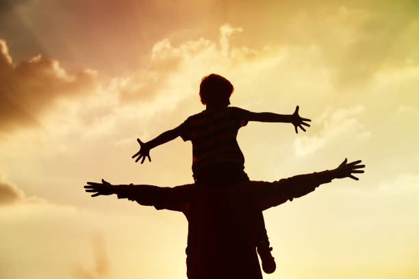 istock father and son play on sunset sky 956316024