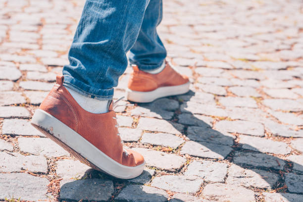 istock Walk on the stone pavement in leather boots 956317182
