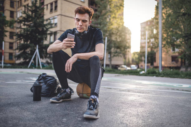 Young and handsome man playing basketball on a basketball court, living the healthy lifestyle.