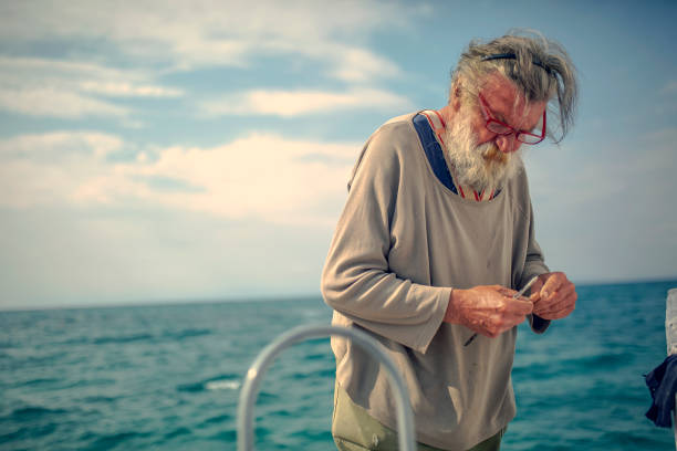 istock Old fisherman by the sea 956321116