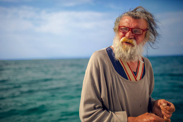 istock Old fisherman by the sea 956321470