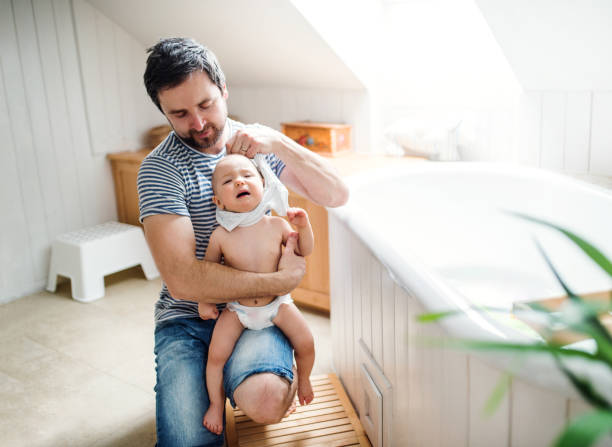 istock Father with a toddler child at home, getting ready for a bath. 956321488