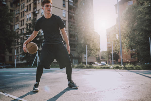 istock Playing basketball outdoors 956322446