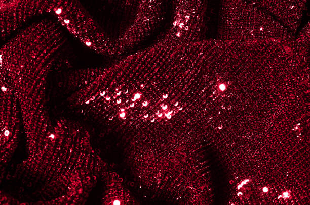 istock Texture, background, pattern, red fabric with paillettes. Look at these neon red sequins. Round neon pink sparkles glitter overlapping iridescent glitter on a clean purple grid. 956322504
