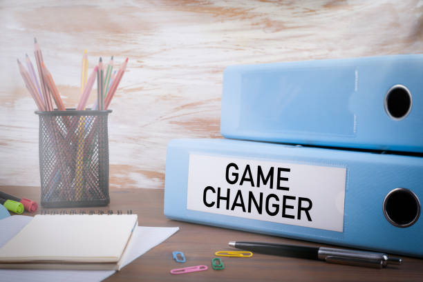 istock Game Changer, Office Binder on Wooden Desk 956322756