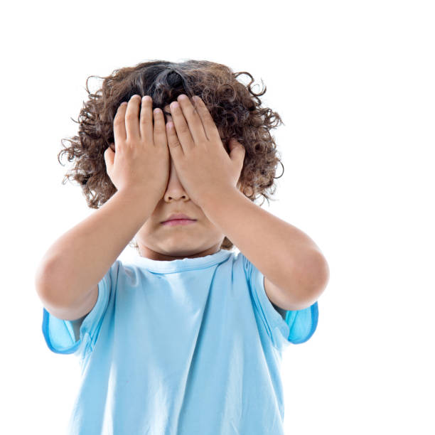 istock Little asian boy covering eyes against white background 956325016