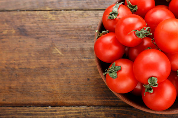 istock ripe tomatoes in a plate on a wooden background 956326474