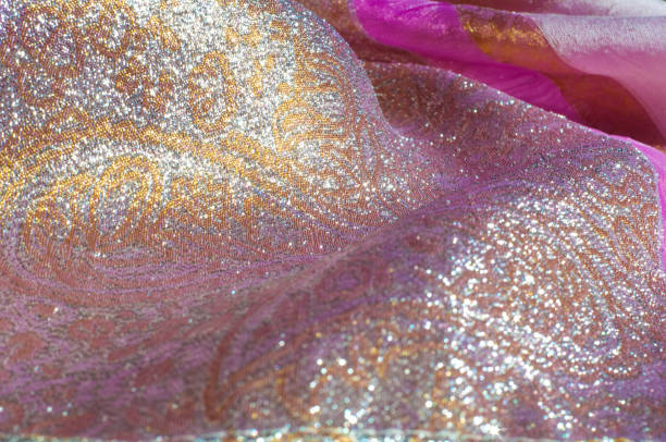 istock Texture, background, pattern. Combined silk white fabric and gold and silver damask fabric, pink ribbons 956326748
