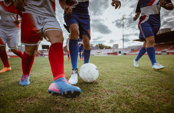 istock Unrecognizable female soccer players in action during the match on a stadium. 956329310
