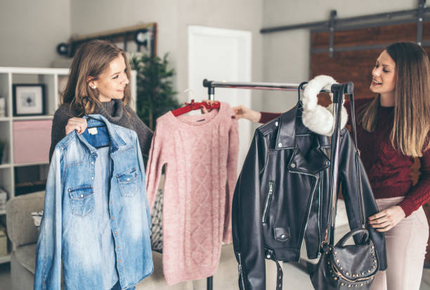istock Two college girls try clothes 956329410