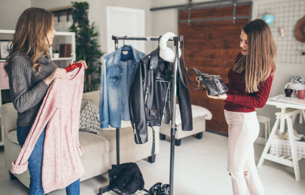 istock Two college girls try clothes 956329412