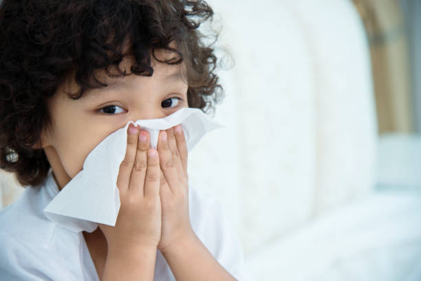 istock Little boy with runny nose in bed 956329716