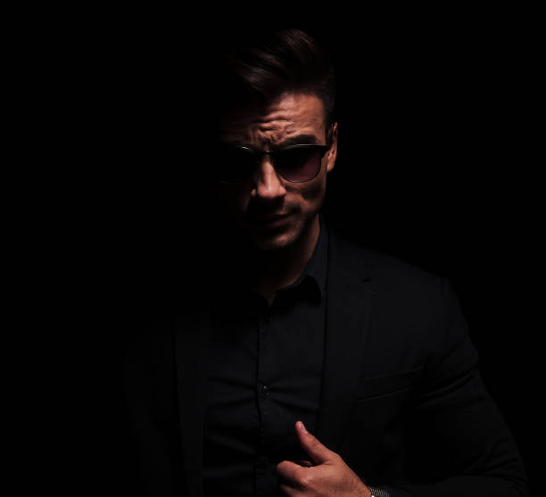 istock sexy and dark fashion man pulling his suit collar 956331578