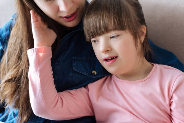 istock Mother tenderly hugging daughter with down syndrome 956331710