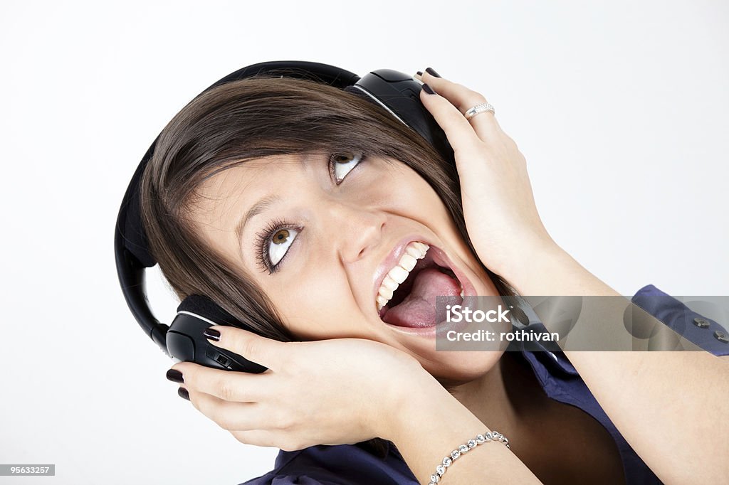 Enjoying music Cute girl listening music over headphones, full frame shot Adult Stock Photo