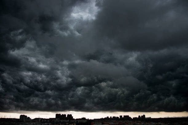 istock Dark stormy clouds over city 956334556