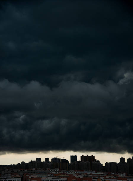 Dark stormy clouds over city.
