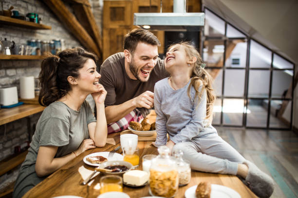 istock Cheerful family having fun while laughing in the kitchen. 956335362