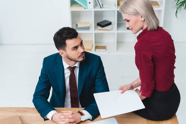 istock young business people working with papers and looking at each other in office 956336844