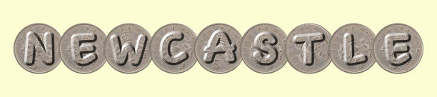 istock NEWCASTLE  written with five new pence coins on yellow background 956337212
