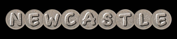 istock NEWCASTLE  written with five new pence coins on black background 956337342
