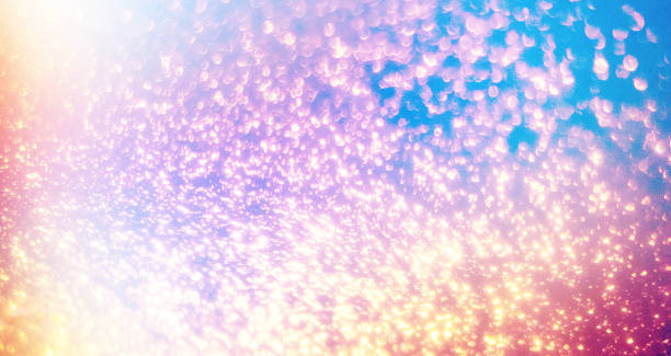 Glittering gradient background  with hologram effect and magic lights. Holographic  abstract fantasy  backdrop  with fairy sparkles, gold stars and festive  blurs. 