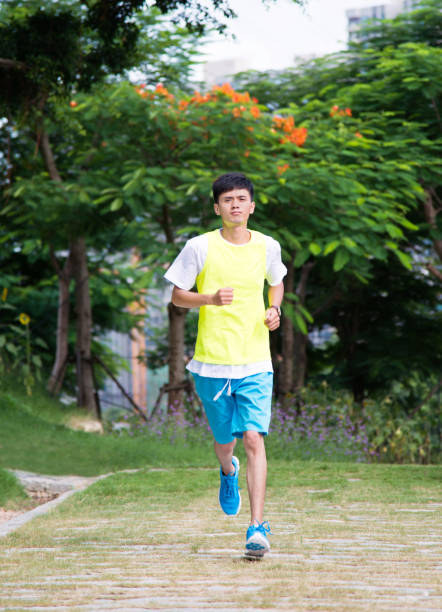 istock Young man jogging in the park 956345454