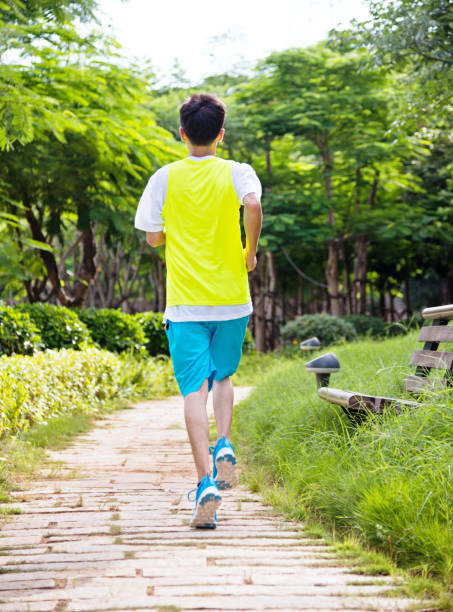 istock Young man running cross country at summer 956345456