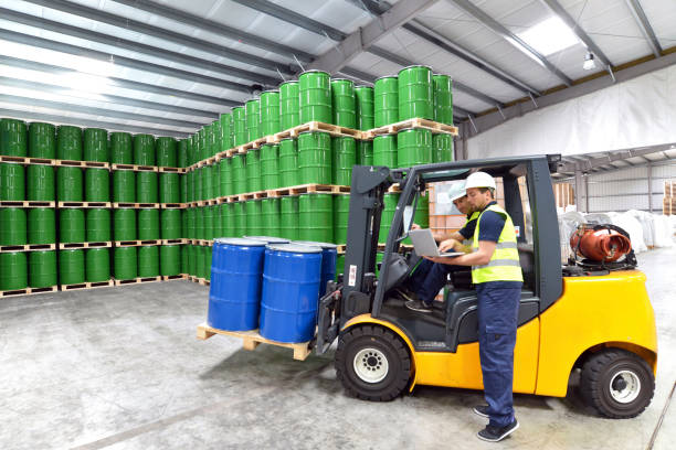 istock group of workers in the logistics industry work in a warehouse with chemicals 956346556