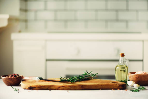 istock Food cooking ingredients on white kitchen design interior background with rustic wooden chopping board in center, copy space 956347080