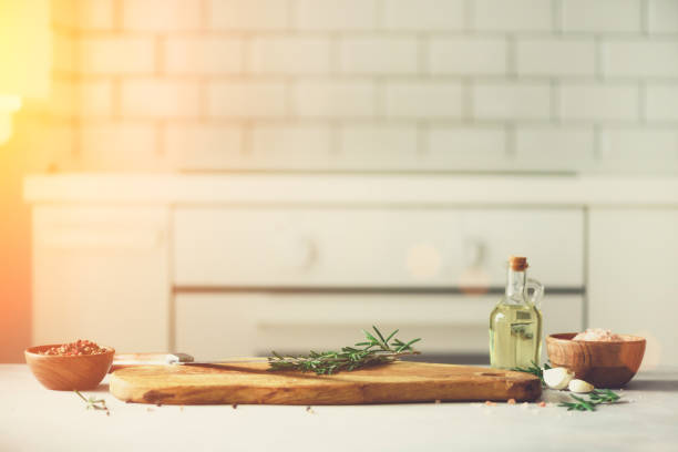 istock Food cooking ingredients on white kitchen design interior background with rustic wooden chopping board in center, copy space 956347150
