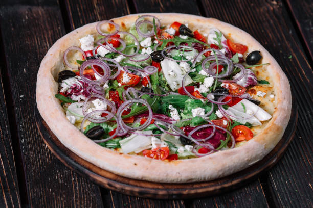 istock Whole vegeterian pizza mozarella on wood background 956347876