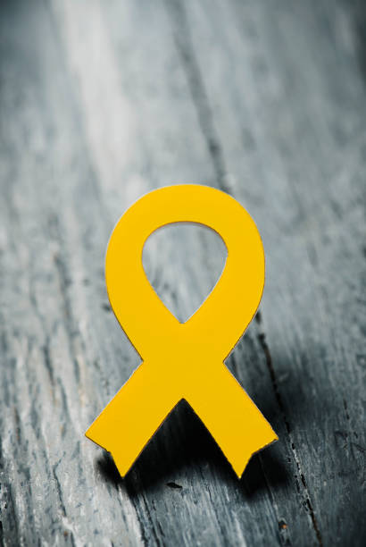 istock yellow ribbon on a wooden surface 956351332