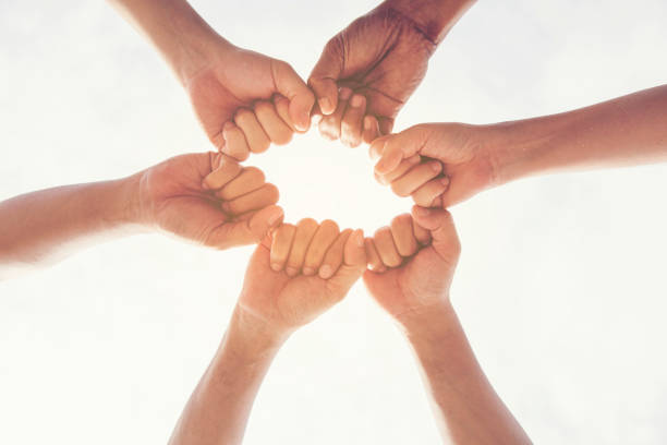 Multiethnic group of young collaboration teamwork standing hands together . Teamwork Concepts.
