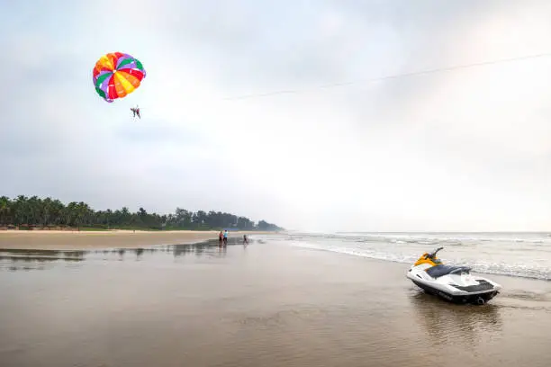 Paraglide lesson on beach with jet-ski in foreground