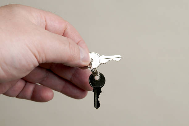 istock closeup of hand holding small cylinder lock keys 956362284
