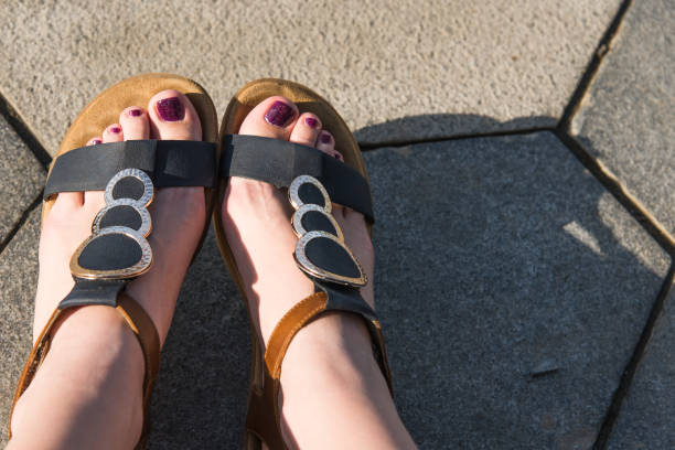istock Female feet in sandals close-up 956363326