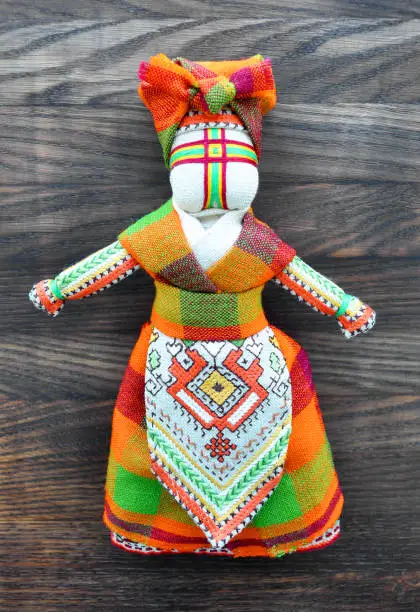 Photo of Motanka doll on the wooden background