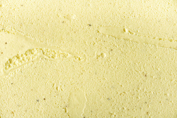 Scooped vanilla ice cream background. Summer food concept, copy space, top view. Sweet yogurt dessert or yellow ice-cream texture stock photo