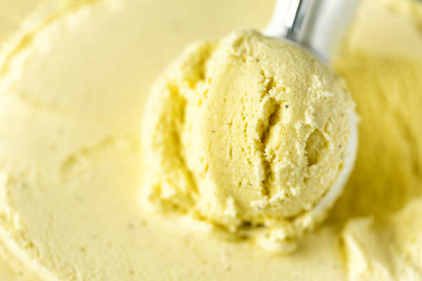 istock Vanilla ice cream scoop background. Summer food concept, copy space, top view. Scooped texture. Scooping out yellow ice-cream 956366074